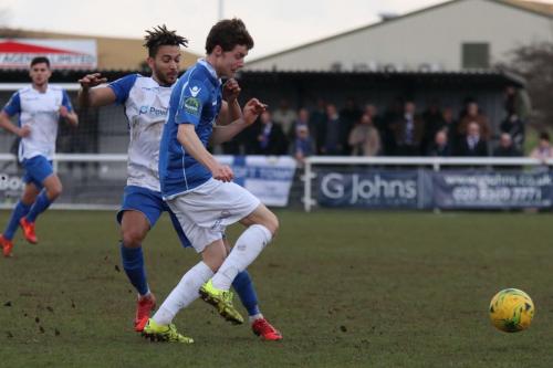 Lowestofts Harvey Hodd (blue) clears from Tyler Campbell