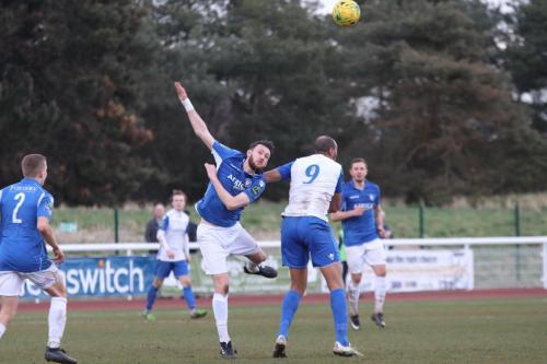 Lowestofts Rory McAuley (blue) and Enfields Simon Thomas