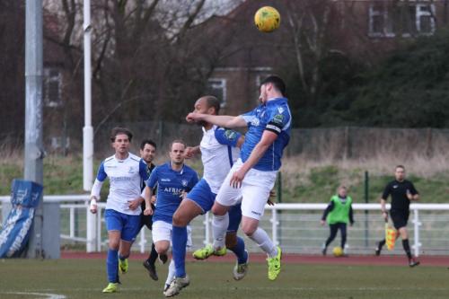Lowestofts Travis Cole (R) wins a challenge with Simon Thomas
