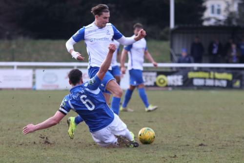 Lowestofts Travis Cole (blue) fouls Sam Youngs