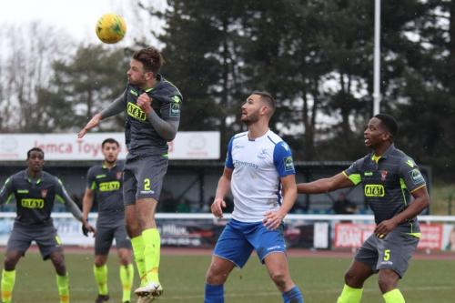 Staines Josh Webb (2) heads clear from Mat Mitchel-King