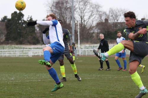 Staines Max Worsfold (R) clears from Aaron Greene