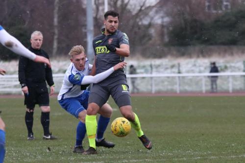 Staines Mo Bettamer (grey) knock the ball away from Ryan Blackman