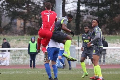 Staines keeeper Conor Hudnott  challenges for the ball with Enfields Brad Wadkins and teammate Ugo Udoji (grey)