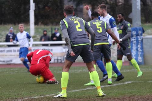 Staines keeper Conor Hudnott recoversa after fumbling a cross
