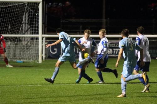 Enfields Mickey Parcell knocks the ball away from Joe Christou (L)