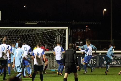 Thurrocks Timothy Ogunrinde (far R) fires a shot onto the post and into the arms of keeper Joe Wright