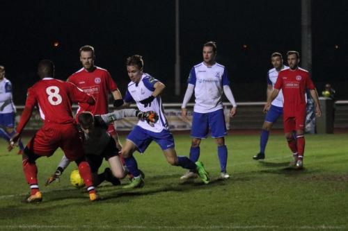 Chipstead keeper Michael Sibley dives for a loose ball in the six-yard box