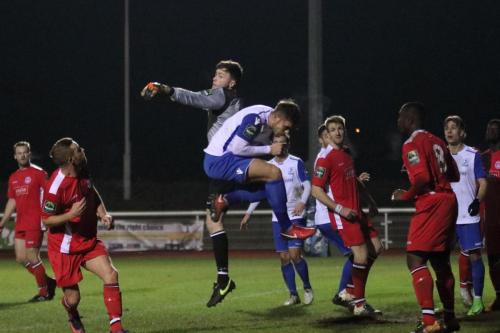 Chipstead keeper Michael Sibley punches clear from Dan Rumens