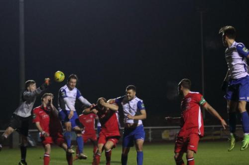 Chipstead keeper Michael Sibley punches clear from Liam Hope