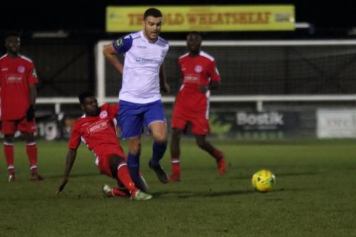 Chipsteads Felix Erivaldo (red) tackles Taylor McKenzie