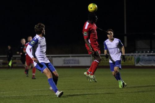 Chipsteads Felix Erivaldo clears from George Beattie (L) and Ben Ward-Cochrane