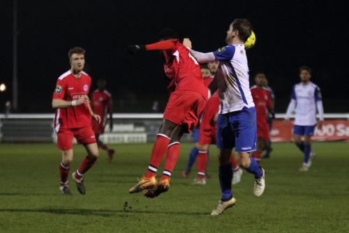 Chipsteads Jeremy Boakye (red) heads clear from Liam Hope