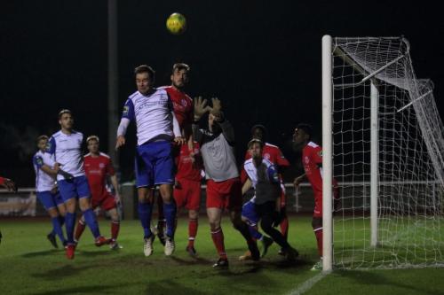 Chipsteads Matthew Males (red) heads clear from Liam Hope