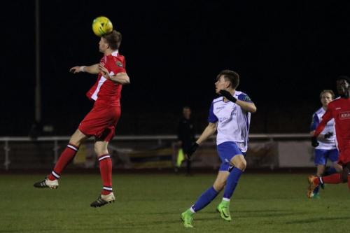 Chipsteads Sam Bell (L) heads clear from Den Ward-Cochrane