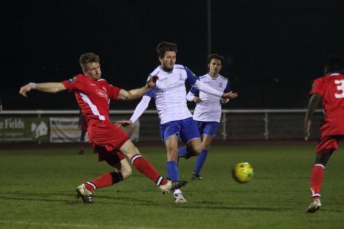 Chipsteads Sam Bell (red) tackles George Beattie