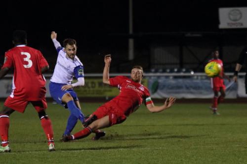 Enfields Jack Hockney shoots as Callum McLean tries to block