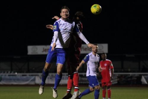 Enfields Liam Hope (L) wins a header