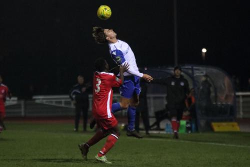 Enfields Sam Youngs wins a header against Felix Erivaldo