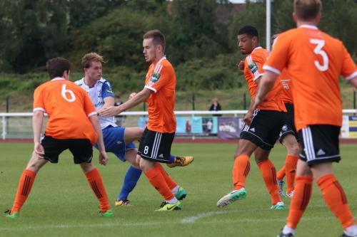 Enfields Aaron Greene shoots through a packed defence