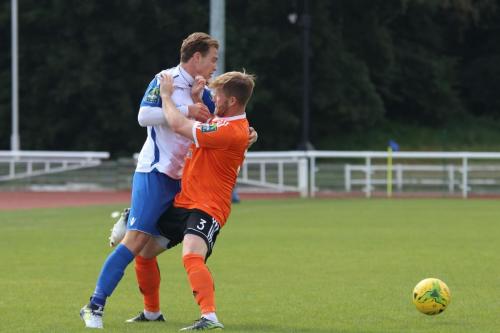 Enfields Mickey Parcell (L) is blocked by Tom Bird