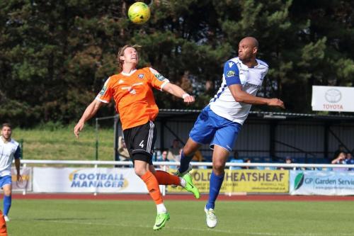 Mets Will Salmon (L) and Enfields Simon Thomas