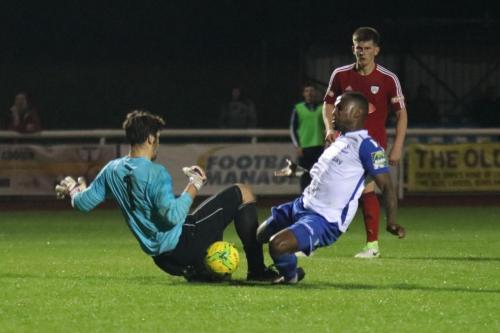 Hanwell keeper Xavi Comas and Enfields Ryan Blake challenge for the ball