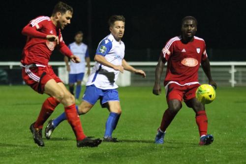 Hanwells Nick Turner (L) clears from Drew Roberts