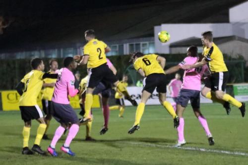 Invictas Josh Vincent (2) and Matt Newman (6) miss the ball allowing Simon Thomas to open the scoring for Enfield