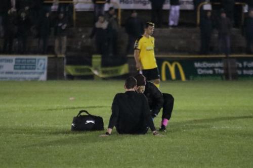 Referee Simon Finnigan receives treatment before having to leave the game