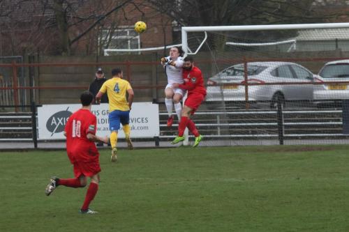 Enfield keeper Joe Wright punches clear from Ryan Moss