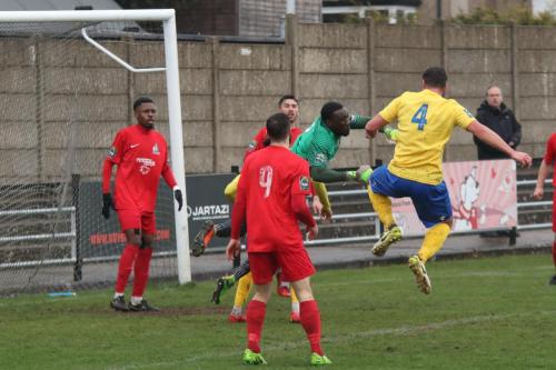 Enfields Adam Martin (4) challenges Harrow keeper Melvin Minter