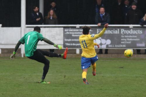 Harrow keeper Melvin Minter clears from Tyler Campbell