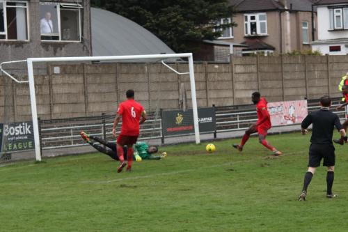 Harrow keeper Melvin Minter palms a cross to safety