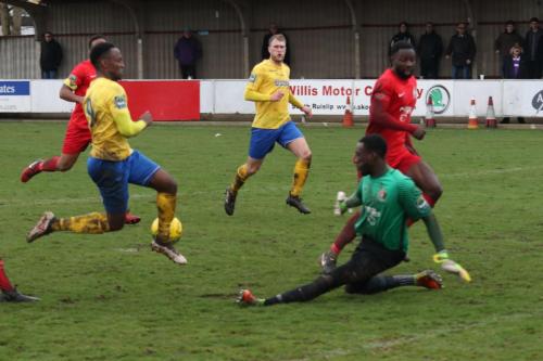 Harrow keeper Melvin Minter saves from Ryan Blake