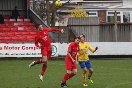 Harrows Adam Richards (L) heads clear
