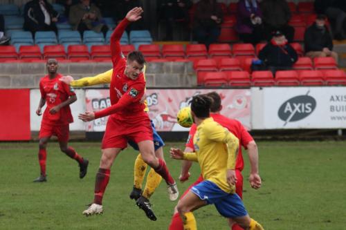 Harrows Adam Richards (red) wins a header