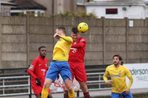 Harrows Adam Richards (red, R) heads clear from Mat Mitchel-King