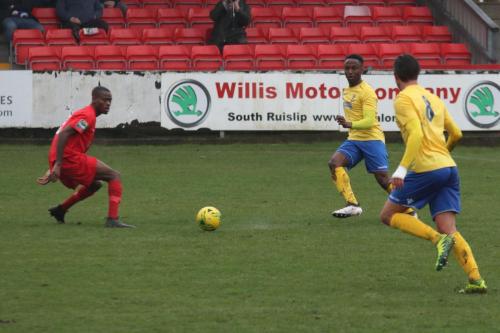 Harrows Chinua Cole (L) and Enfields Ryan Blake and Sam Youngs (R)