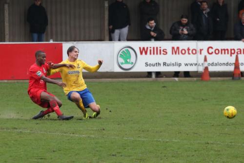 Harrows Chinua Cole (L) wins a tackle against Sam Youngs
