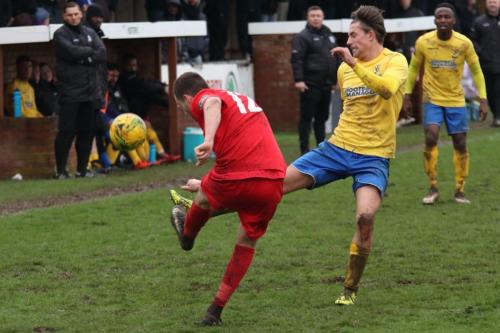 Harrows Mark McLeod (red) clears from Sam Youngs