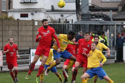 Harrows Ryan Moss (2nd L) heads clear from Ryan Blake