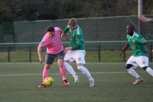 Enfields Drew Roberts (L) holds off Keagan Cole as Daniel Uchechi looks on