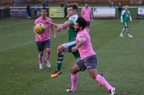 Enfields Mario Noto (R) challenges Sam Blackman