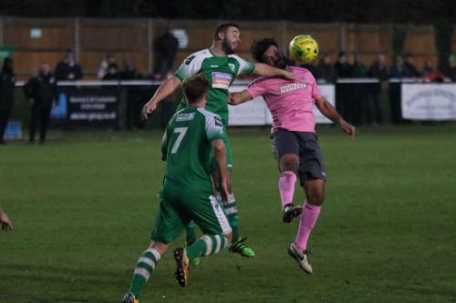 Enfields Mario Noto (R) challenges Sammy Moore