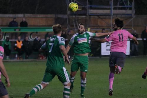 Enfields Mario Noto (R) flicks a header past Sammy Moore and Sam Blackman (7)