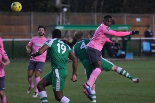 Enfields Ryan Blake (R) wins a header against Lee Minshull (4) as Jerry Nnamani covers