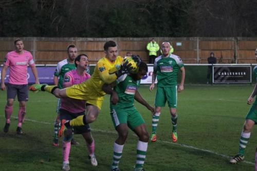Leatherhead goalkeeper Zaki Oualah beats Elliot Benyon (pink) to the ball