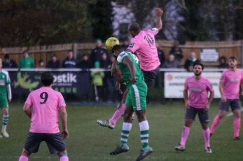 Leatherheads Jerry Nnamani (green) heads clear from Simon Thomas