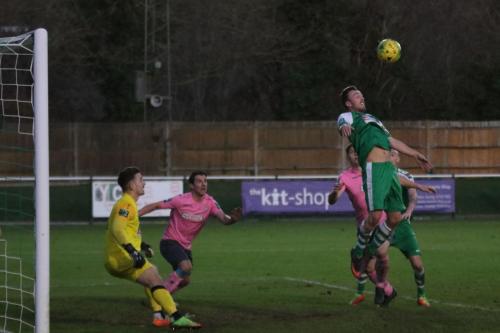 Leatherheads Niall McManus (green) wins a header